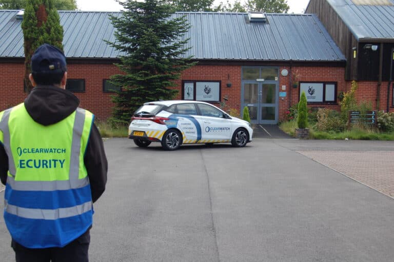 Clear Watch Security officer and response vehicle attending a commercial site